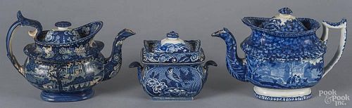 Two historical blue Staffordshire teapots, 8 1/4'' h., 11 1/2'' w., and a covered sugar, 19th c.