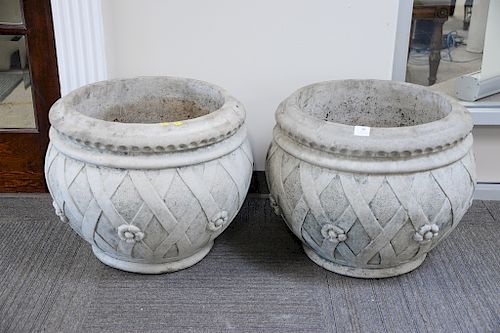 Pair of large Nina Studio cement planters, basket weave and flower. ht. 19 in., dia. 22 in. Provenance: From the Estate of Deborah G. Black of Greenwi