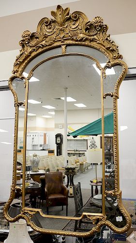 Large George II style giltwood border glass mirror, arched crest with foliate scrolls and shells. ht. 67 in., wd. 37 3/4 in. Provena...