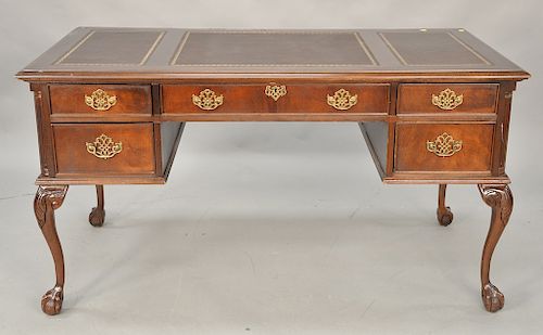 Mahogany Chippendale style executive desk having three panel leather top and ball and claw feet. ht. 30 1/2 in., top: 28" x 56"