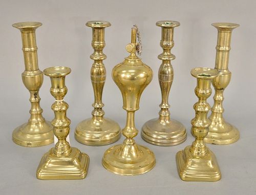 Seven piece to include three paris of brass candlesticks (including a pair of push up candlesticks) and an oil lamp. ht. 7 1/2 in. t...