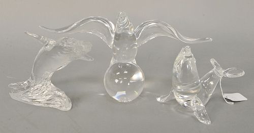 Three glass sculptures to include Steuben bird on ball with wings spread (ht. 7 in.), Steuben Seal (ht. 5 in.), and a Waterford whal...
