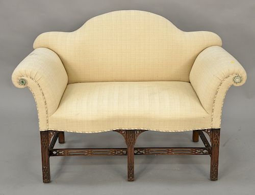George III style upholstered mahogany settee of serpentine top raised on fret carved legs. lg. 48 in. Provenance: From the Estate of...