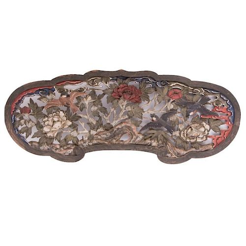 A carved Japanese wood panel.
