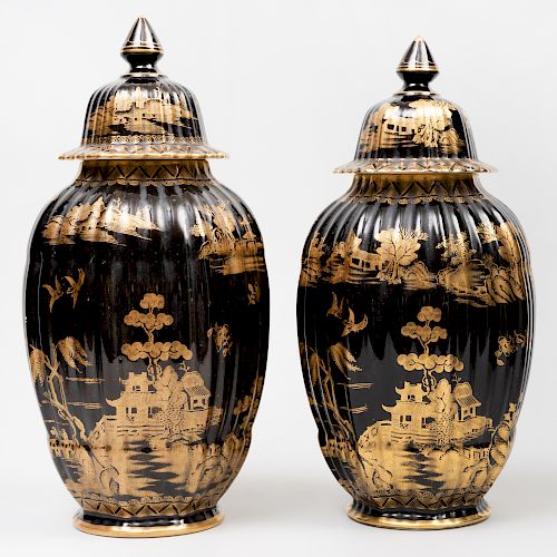 Near Pair of Booth's Porcelain Gilt-Decorate Black Ground Jars and Covers in the 'Willow' Pattern