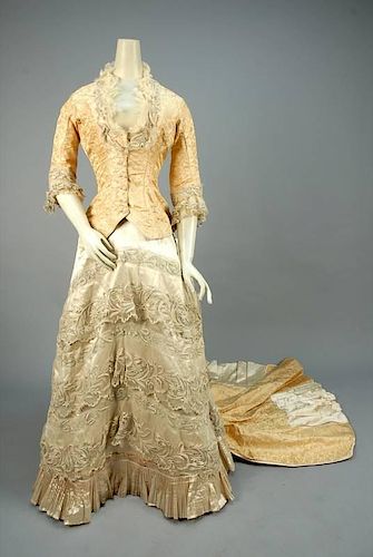 TRAINED SILK and LACE WEDDING GOWN, 1878.