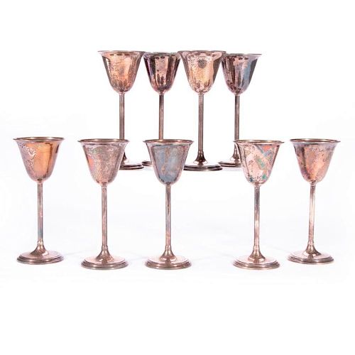A set of nine sterling fluted drinking cups.