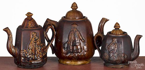 Three Rockingham type teapots, ca. 1900, two with robed Chinese figures