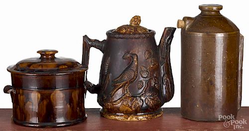 Rockingham type coffeepot, 19th c., with bird decoration, 9'' h., together with a covered butter tub
