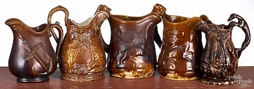 Five Rockingham type pitchers, ca. 1900, tallest - 7 1/2''.