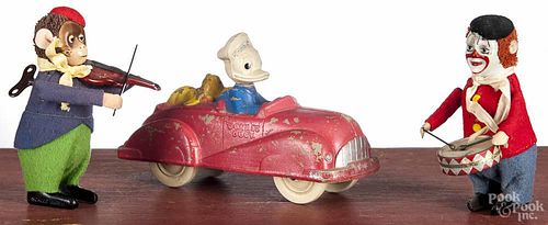 Two Schuco wind-up toys, to include a clown playing drums and a monkey playing a violin, 4 1/2'' h.