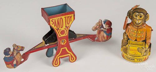 Chein tin litho see saw sand toy, 5 1/4'' h., together with a Chein semi-mechanical tin litho