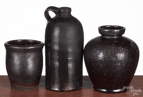 Three pieces of redware, 19th c., to include a jug, 8'' h., an ovoid jar, 6 1/2'' h.