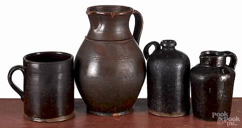 Two redware pitchers, 9 3/4'' h. and 5 3/4'' h., together with a jug, 6 3/4'' h., and a mug, 5 1/2'' h.