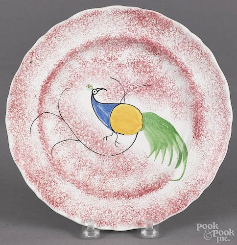 Red spatter plate, 19th c., with a peafowl, 7 1/2'' dia.