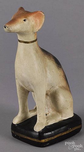 Chalkware figure of a seated spaniel, mid 20th c., with a solid body, 8'' h.
