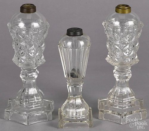 Three clear glass whale oil lamps, tallest - 10 1/2''.