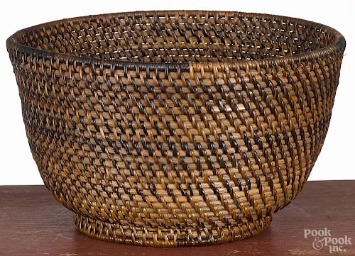 Nantucket basket, 20th c., with a footed rim, 6'' h., 10'' dia.