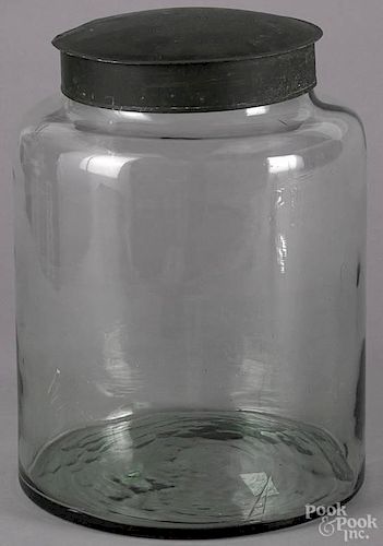 Large tin country store blown glass jar, 20th c., with a green painted tin lid, 14'' h.