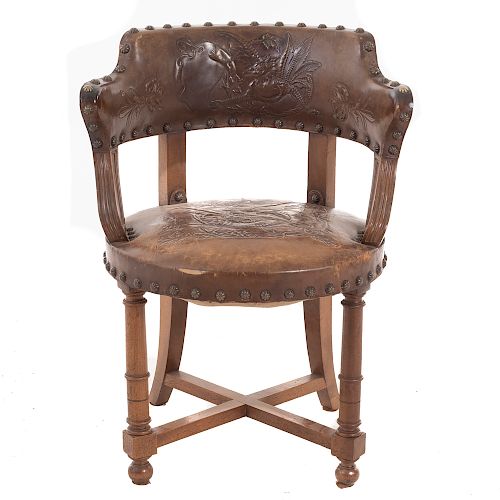 Sillón. Francia. Siglo XX. Estilo Enrique II. En talla de madera de nogal. Con respaldo semiabierto y asiento de piel color marrón.