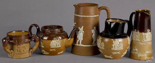 Four Royal Doulton Lambeth pottery pieces, ca. 1900, to include a loving cup, a teapot