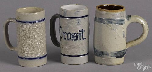 Three blue and white stoneware mugs, early 20th c., one inscribed Prosit