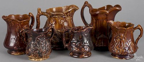 Six Rockingham type pitchers, 19th c., tallest - 9 1/2''.