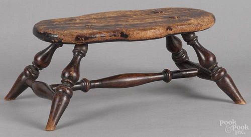 Windsor style pine foot stool, late 19th c., with turned splayed legs and a shaped top, 6 1/2'' h.