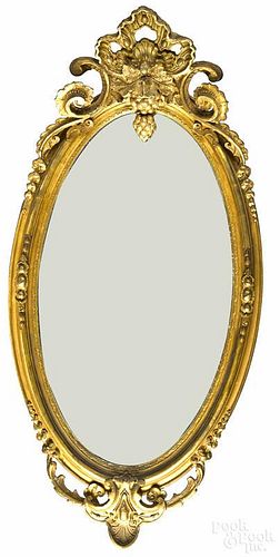 Empire giltwood mirror, mid 19th c., with a shell and grape scrolled crest, 53'' h.