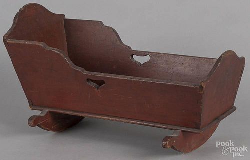 Pennsylvania pine doll cradle, 19th c. with heart cutouts, retaining an old red stained surface