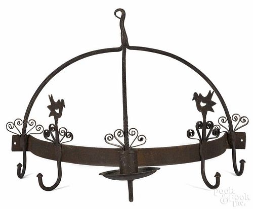 Wrought iron hanging pot rack, 20th c., with a candleholder and bird finials, 14'' h., 19'' w.