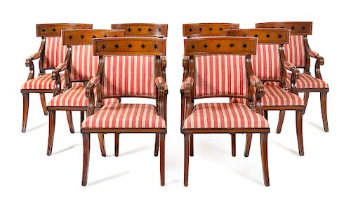 A Set of Sixteen Regency Style Parcel Ebonized Mahogany Dining Chairs