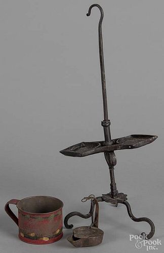 Wrought iron betty lamp stand, 20th c., 18'' h., together with a tin betty lamp and a toleware cup.