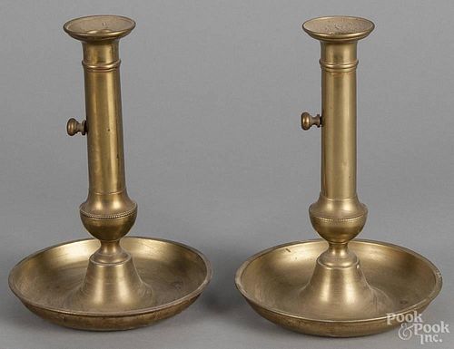 Pair of brass push-up candlesticks with drip pan bases, 19th c., 9'' h.