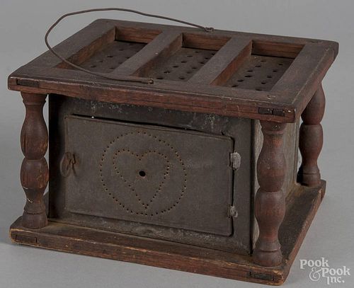 Walnut and punched tin footwarmer, 19th c., with heart decoration, 5 3/4'' h., 9'' w.