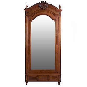Armario. Francia. Siglo XX. Estilo Luis XVI. En talla de madera de nogal. Puerta con espejo de luna irregular biselada, cajón.