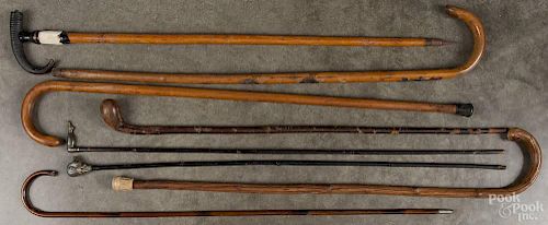 Eight canes, 19th/20th c., to include a souvenir cane from Interlocken, one with a plated pig head