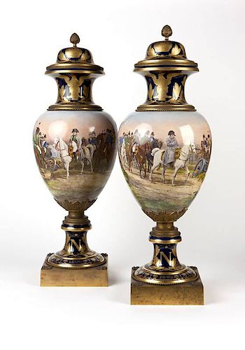 A pair of mounted Sevres style Napoleonic lidded urns