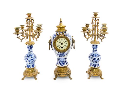 A Delft Pottery Three-Piece Clock Garniture