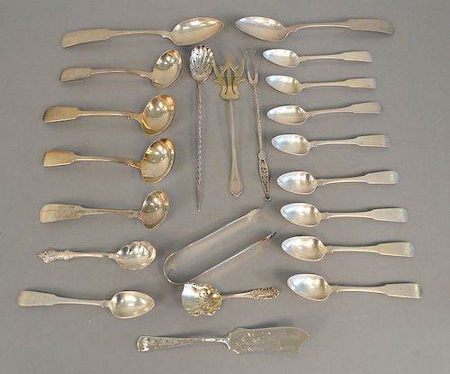 Silver lot to include coins, sterling silver spoons, and three small English silver ladles. 20.9 troy ounces.
