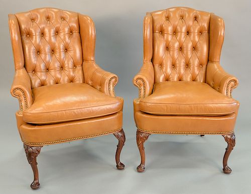 Pair of custom leather upholstered ladies wing chairs with tufted backs, ht. 42 in., wd. 29 in.