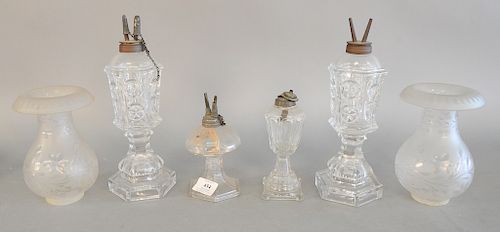 Lot of four whale oil lamps plus two frosted chimney shades. ht. 6 1/2 in. to 11 1/2 in.