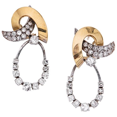 A diamond 14K yellow gold and palladium silver pair of earrings.