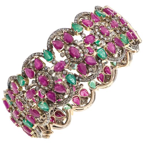 A ruby, emerald and diamond 10K yellow gold bangle bracelet.