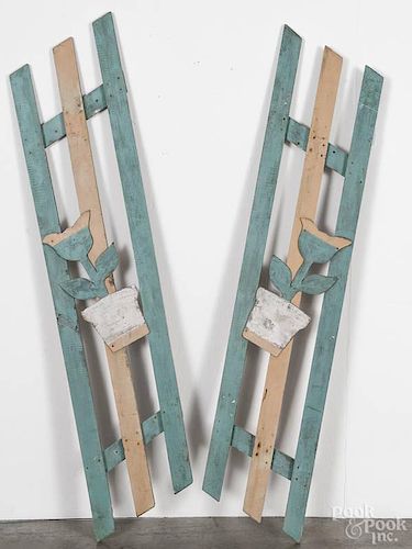 Pair of painted picket fence shutters, early 20th c., with applied pressboard potted tulips