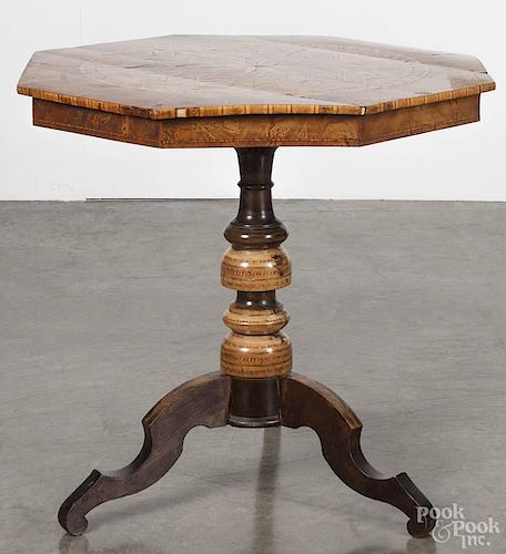 Italian marquetry inlaid tea table, 19th c., with an octagonal top, over a turned standard