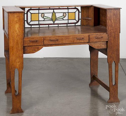Oak arts and crafts writing desk, early 20th c., with stained glass gallery, 39'' h., 46'' w.