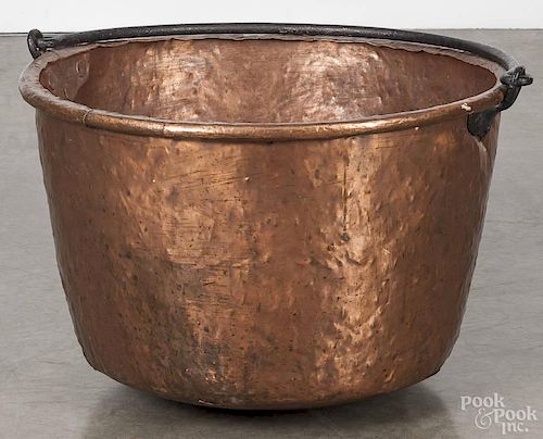 Large copper apple butter kettle, early 19th c., with an iron swing handle, 16 1/2'' h., 24'' dia.