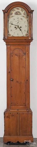 English pine tall case clock, early 19th c., with an eight-day movement and a painted face, 79'' h.