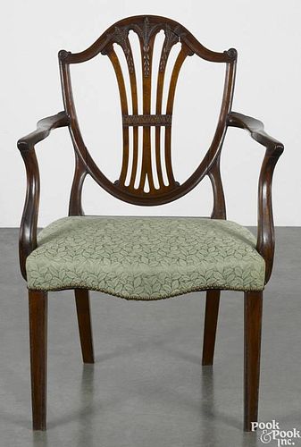 George III mahogany shieldback dining chair, ca. 1790, with carved sheaf of wheat and bellflower decoration.